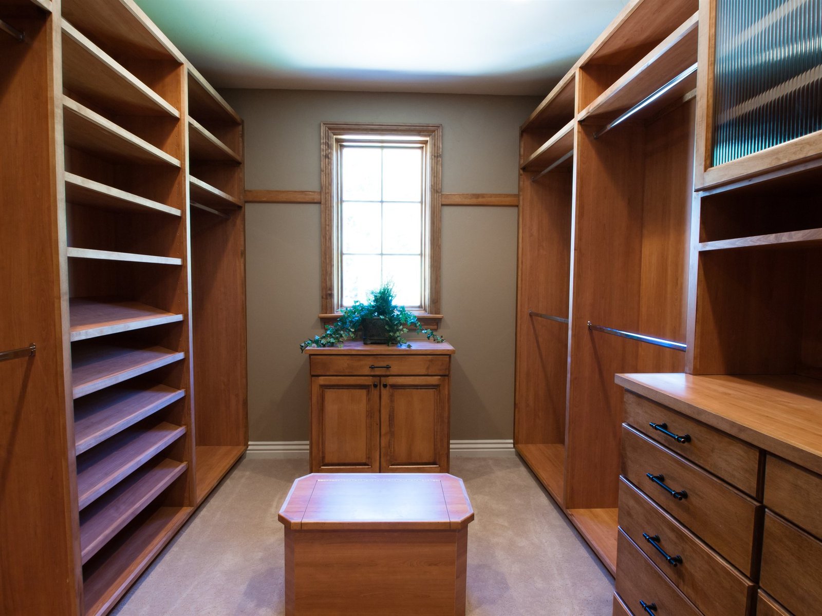 Master dressing room custom walk-in closet with wooden shelves and drawers